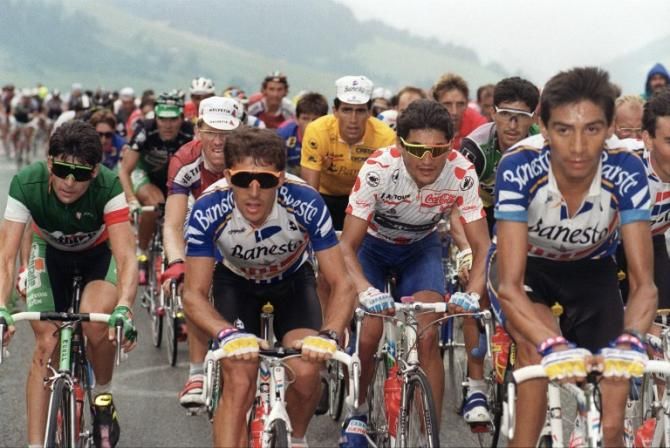 Miguel Indurain (Banesto) in yellow in the background during the 1991 Tour, his first of five straight Tour victories. In the foreground is Italian champion Gianno Bugno, Indurain's super domestique Pedro Delgado and mountains leader Claudio Chiappucci
