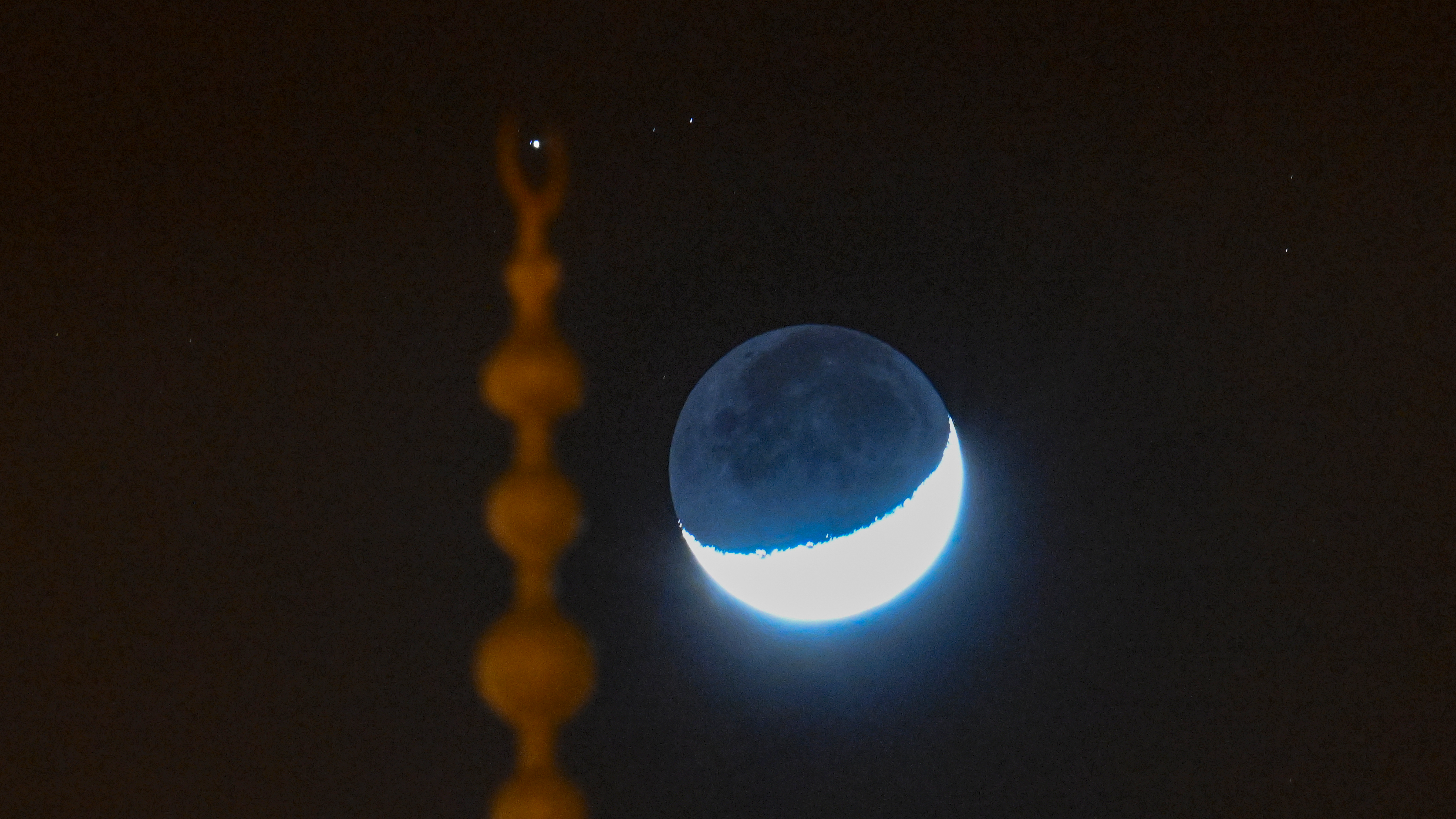 A view of the crescent moon and Saturn's alignment, observed in the skies over Turkiye's Van, on January 4, 2025. (Photo by Ozkan Bilgin/Anadolu via Getty Images)
