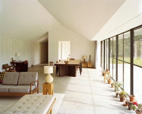 living space with potted plants and grey sofa