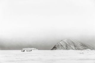 The vast expanse of Greenland with indigenous people travelling across