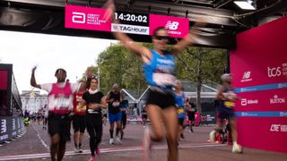 Motion blur image as runners from the mass start cross the finish line after completing The TCS London Marathon on Sunday 2nd October 2022