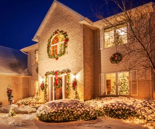 Golden Christmas lights decorating the front of a home