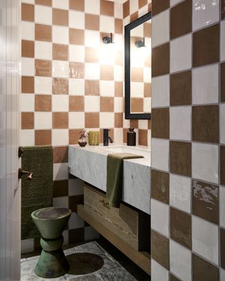 a brown checkerboard bathroom with green accents