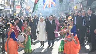 King Charles III and Camilla, Queen Consort meet members of the public during a visit to the Bangladeshi community of Brick Lane on February 8, 2023 in London, England. The King and Queen Consort meet local charities and businesses as well as members who were actively involved in the anti-racism movement of the 1960's and 1970's.