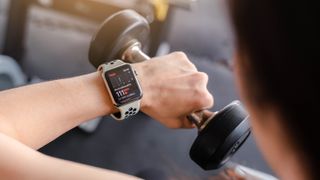 An image showing a person using an Apple Watch while exercising