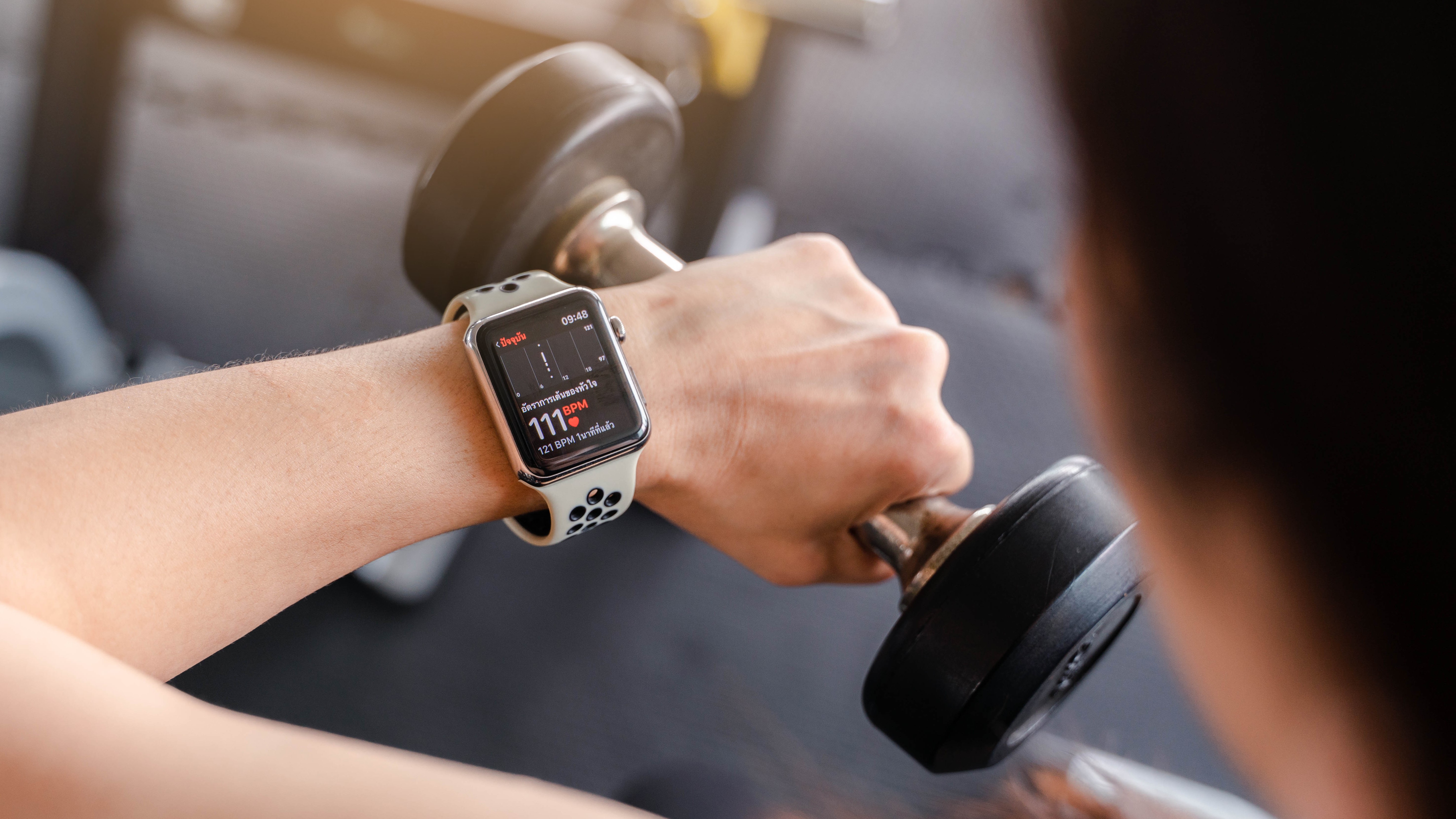 An image showing a person using an Apple Watch while exercising