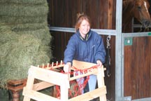 Girl_puts_haynet_on_spindles.jpg