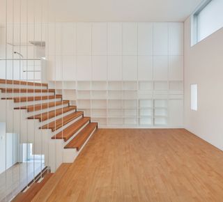 A long bookshelf runs the length of the wall in the family's living area