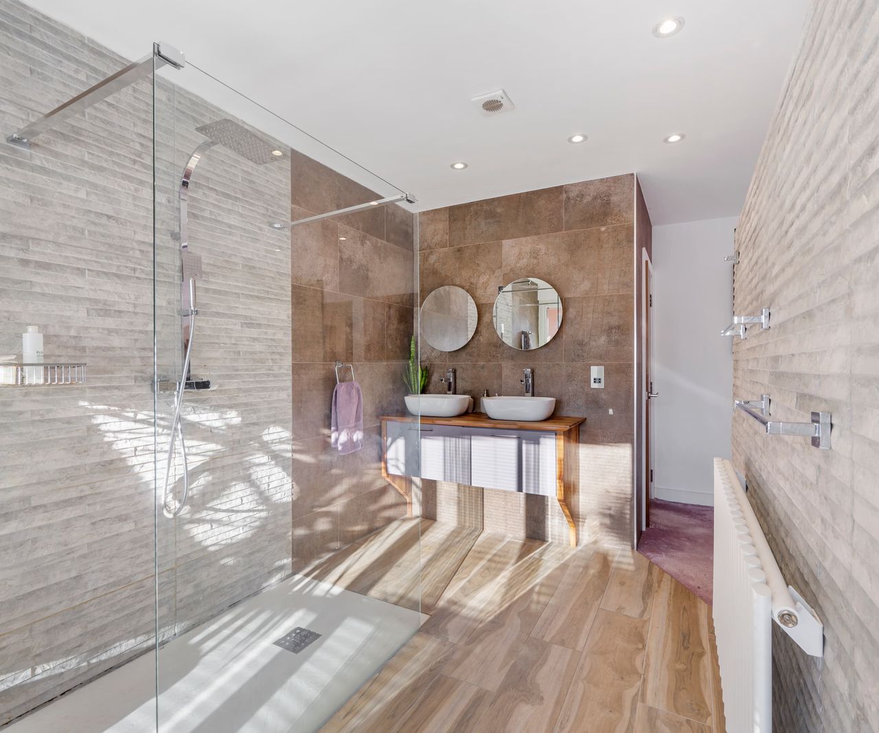 A free standing shower with his and her showers