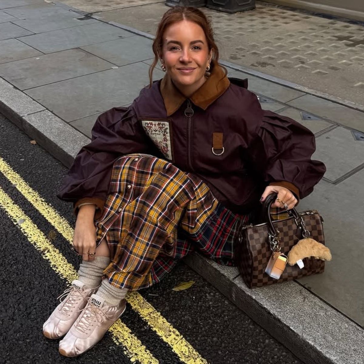 An image of @rebeccaferrazwyatt wearing a pair of pink satin trainers from Miu Miu.