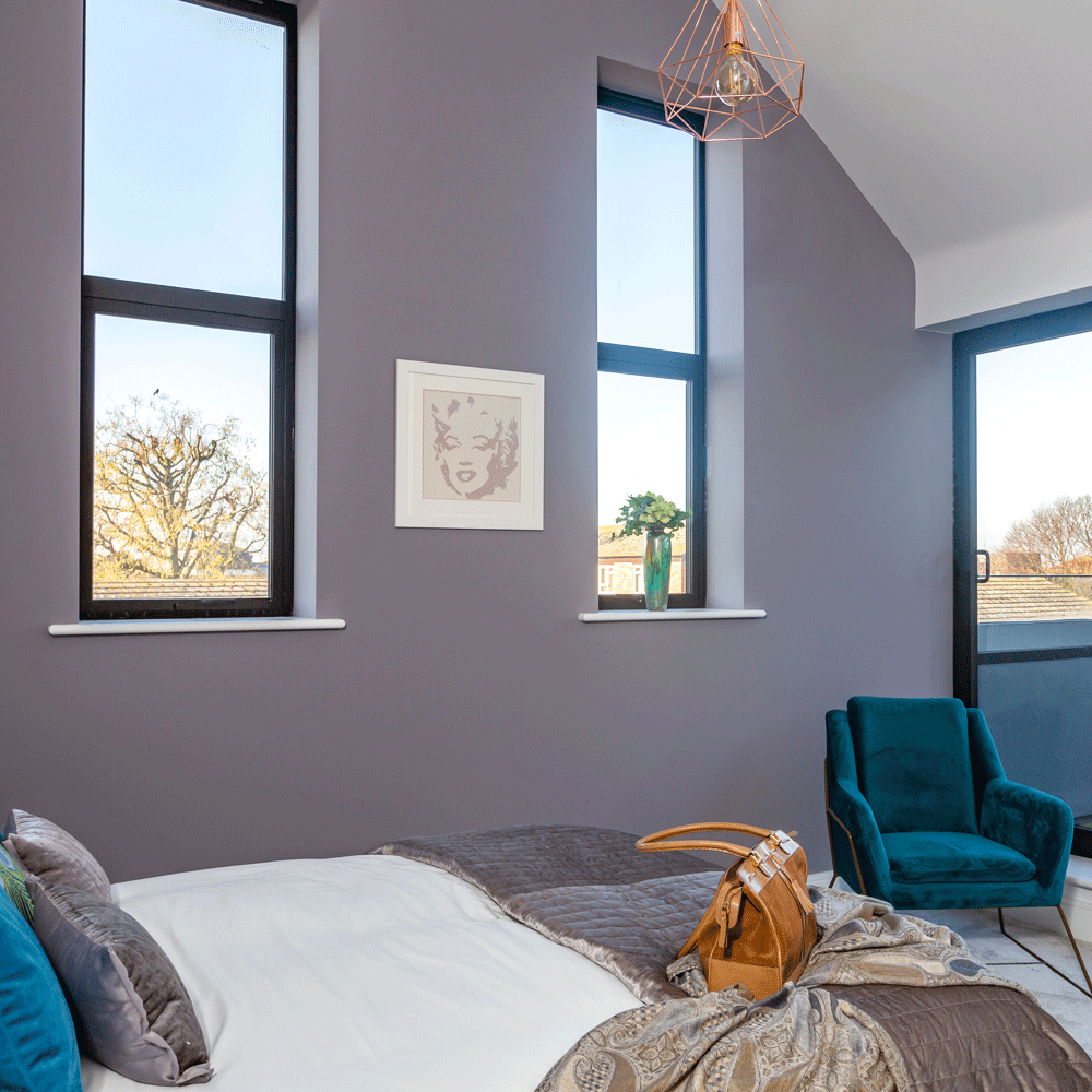 bedroom with vaulted ceilings and grey walls