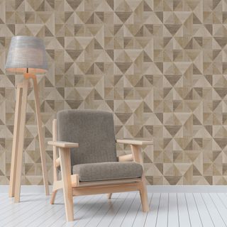 wooden chair next to wooden lamp on grey wooden floor in front of geometric pattern wall