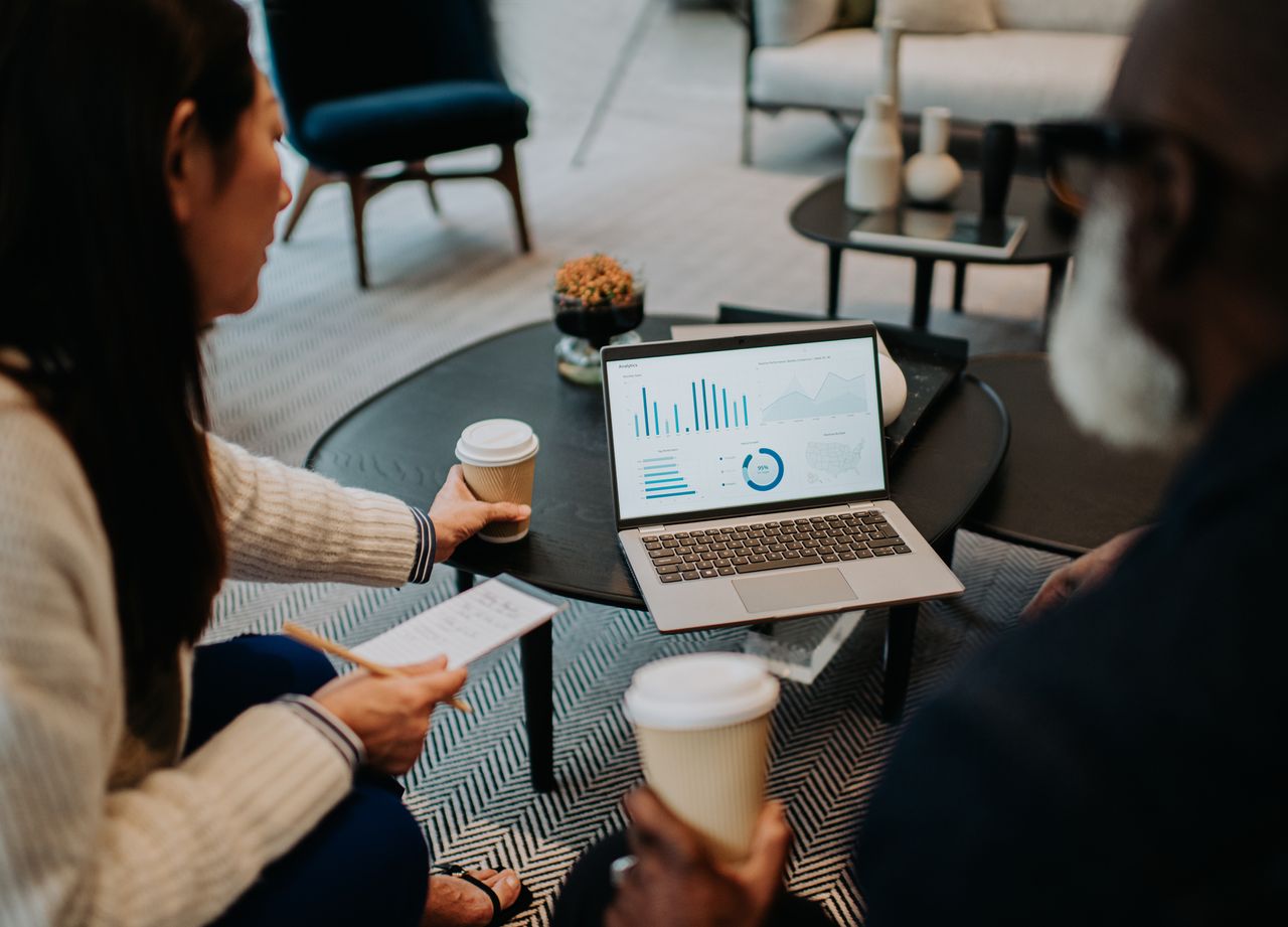 man and woman looking at pension performance