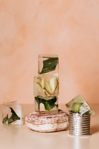 Ice cubes with herbs and leaves frozen