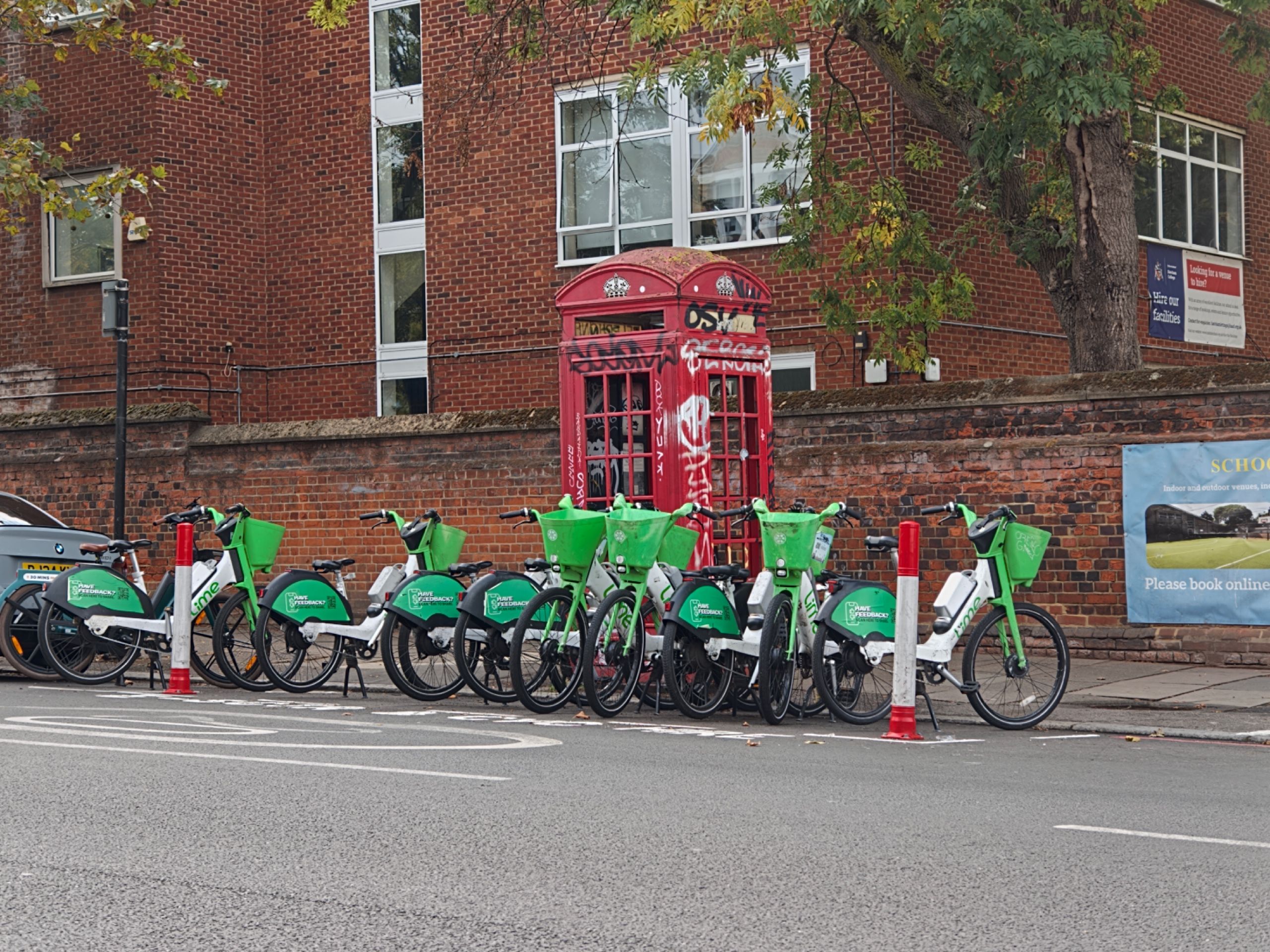 A phone box surrounded by Lime Bikes
