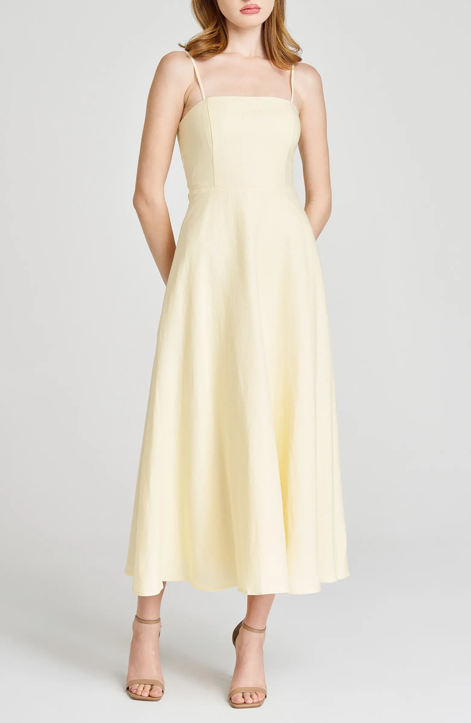 a model wearing a Butter yellow dress