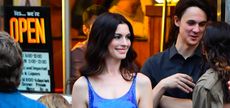 Anne Hathaway wearing a blue shiny dress