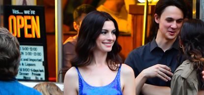 Anne Hathaway wearing a blue shiny dress