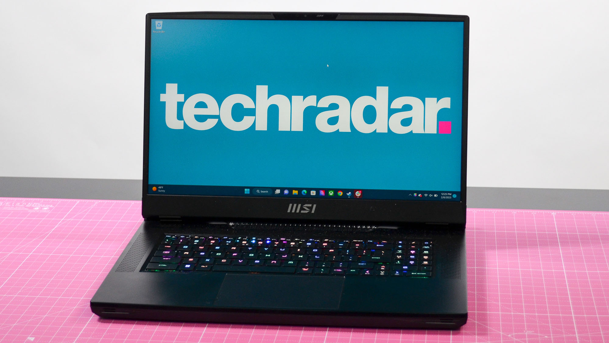 An MSI GT77 Titan on a pink desktop mat