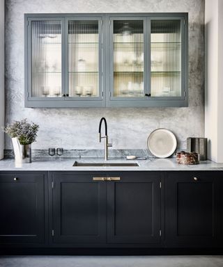 Gray kitchen with cabinets and fluted glass doors