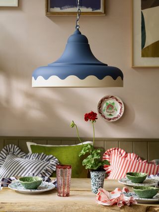 blue and white pendant light above dining table