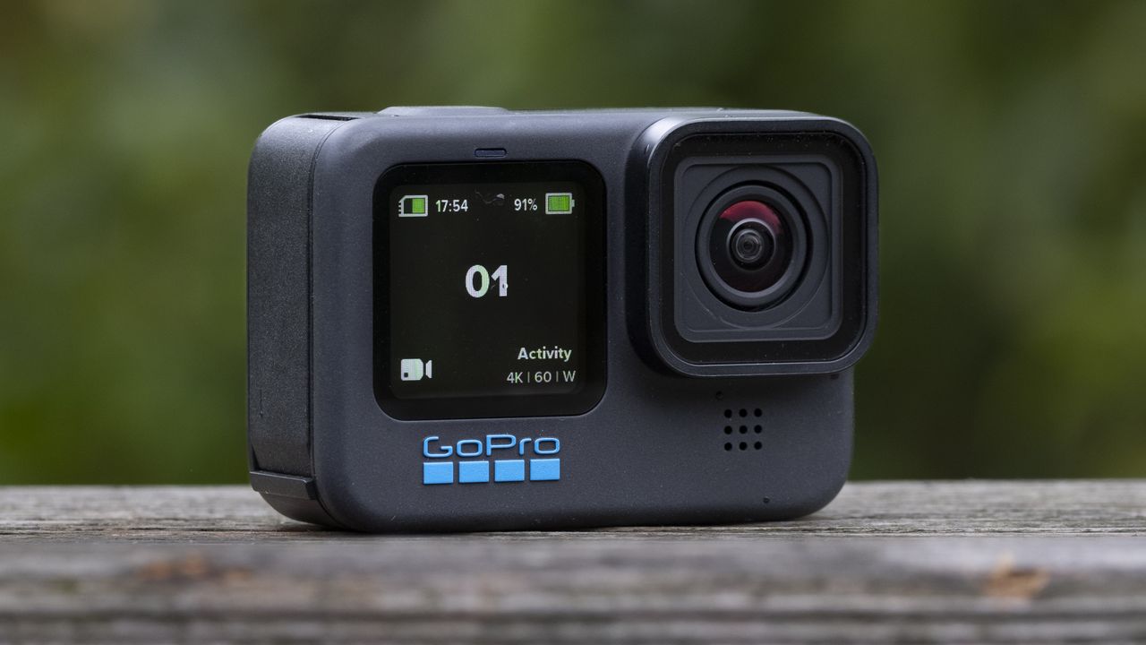 The GoPro Hero 11 Black action camera sitting on a wooden platform