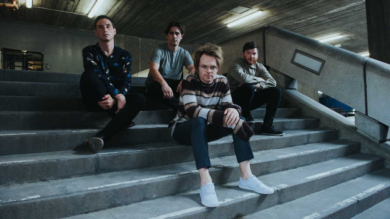 Enter Shikari sat on the stairs