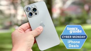 iPhone 15 Pro Max in hand with Cyber Monday deal tag
