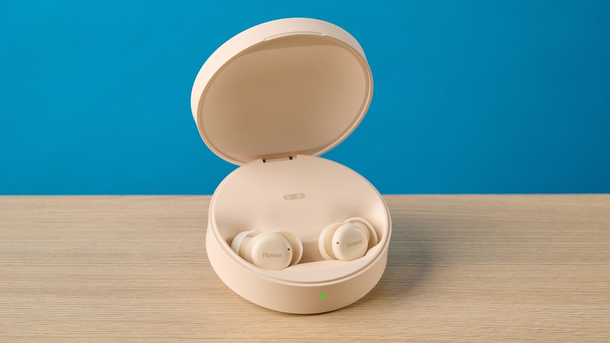 A close up of the Fitnexa SomniPods 3 sleep earbuds in their charging case with the lid open