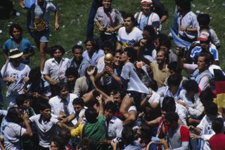 Diego Maradona celebrates with team-mates and fans after Argentina's World Cup final win over West Germany at the Estadio Azteca in June 1986.