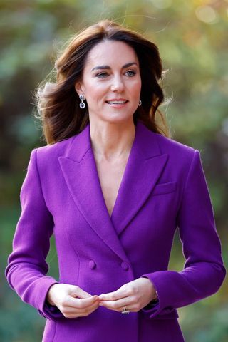 Kate Middleton wears a purple suit.