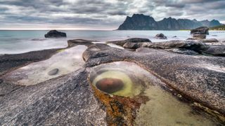 Long exposure photograph of the dragon eye shaped rock at Uttakleiv Beach, Lofoten, the Norwegian Arctic.