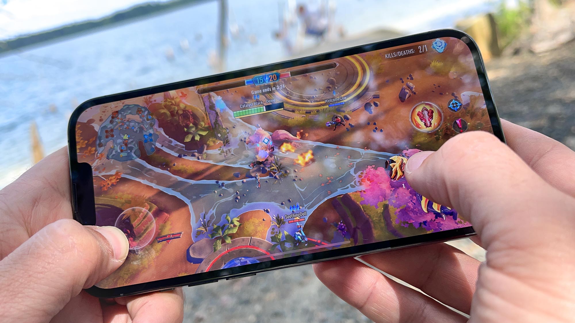 iphone 13 pro max in hand playing a game