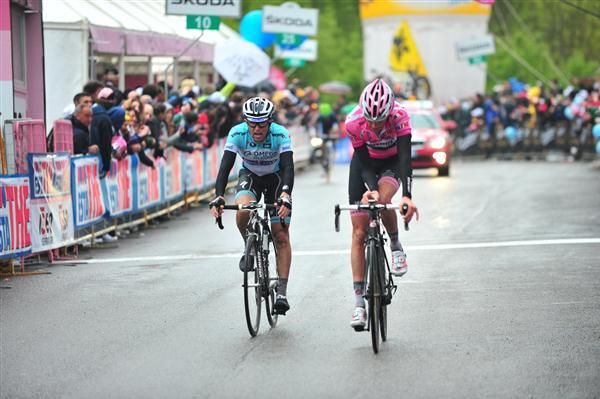 Pink jersey incumbent Ryder Hesjedal reaches the finish, flanked by Dario Cataldo of Omega Pharma-QuickStep