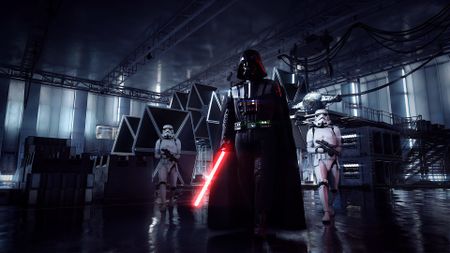 Star Wars Battlefront 2 (2017) screenshot showing Darth Vader walking through a hangar flanked by two stormtroopers
