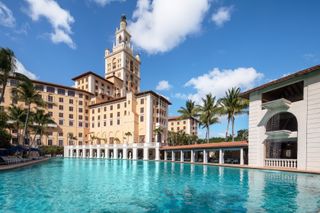 The massive pool at the Biltmore Hotel Miami-Coral Gables with blue skies in the background