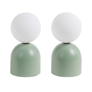 pair of green table lamps with globe bulbs