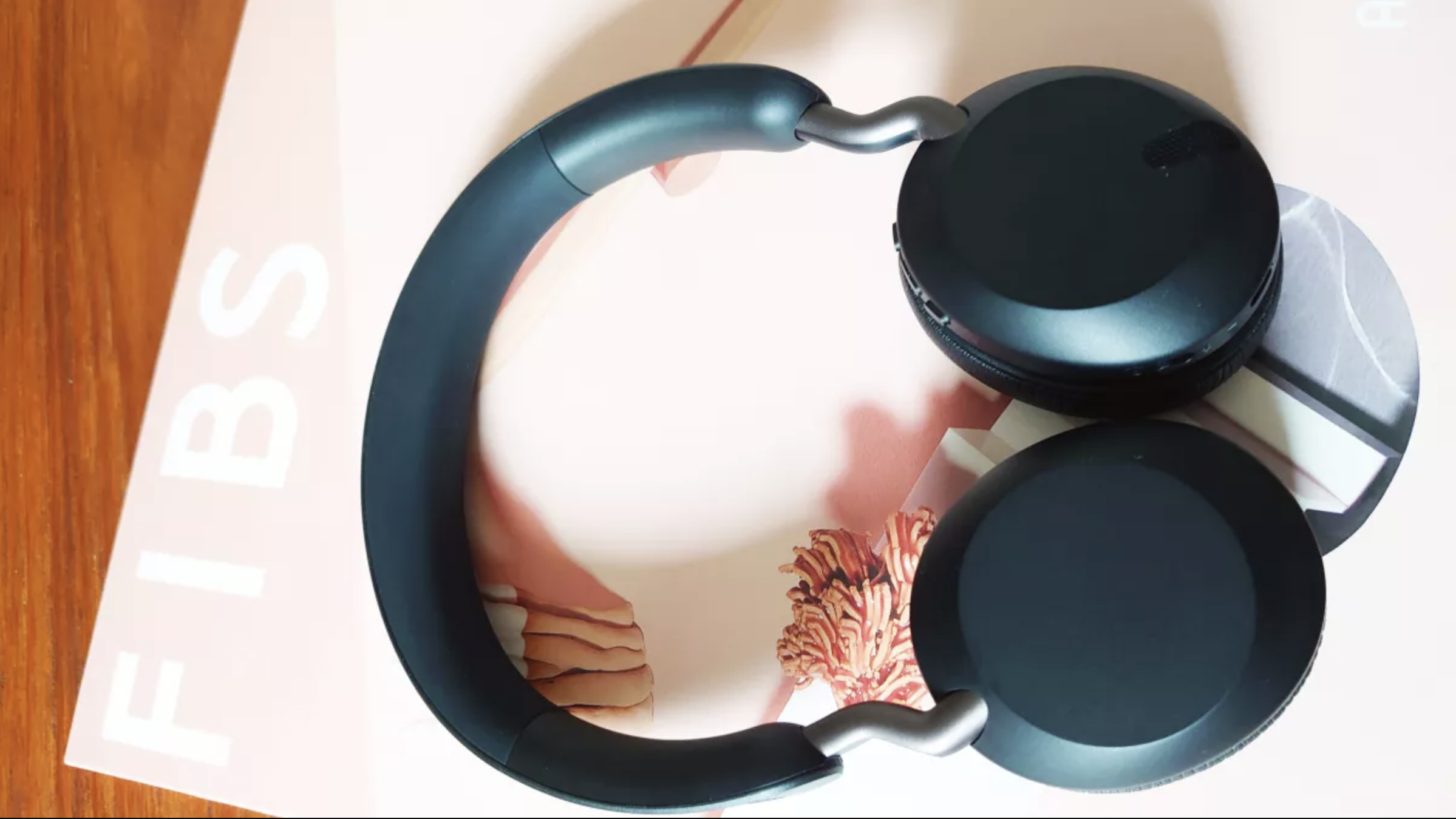 The Jabra Elite 45h wireless headphones in black on a wooden surface