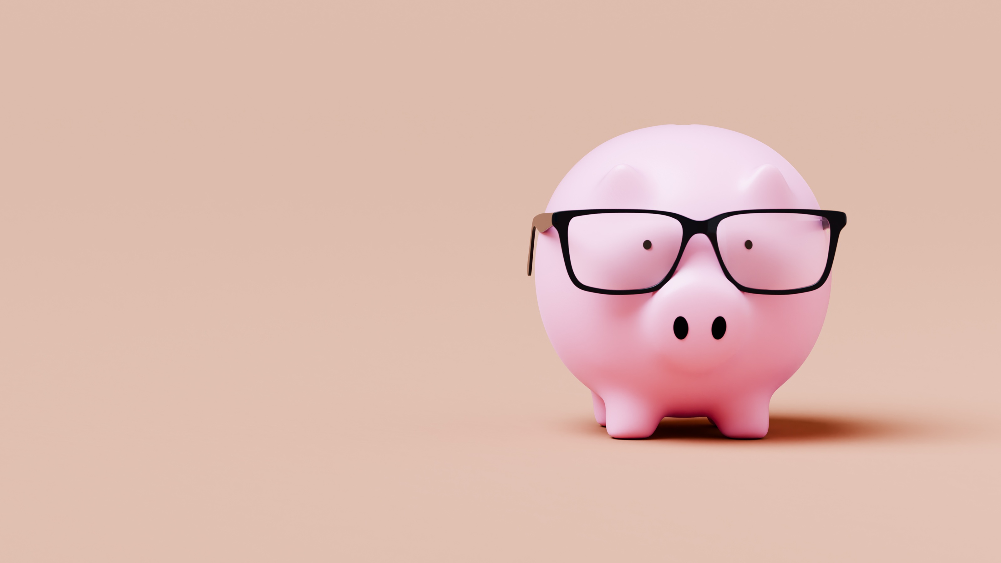 Piggy bank wearing glasses against a rose background.