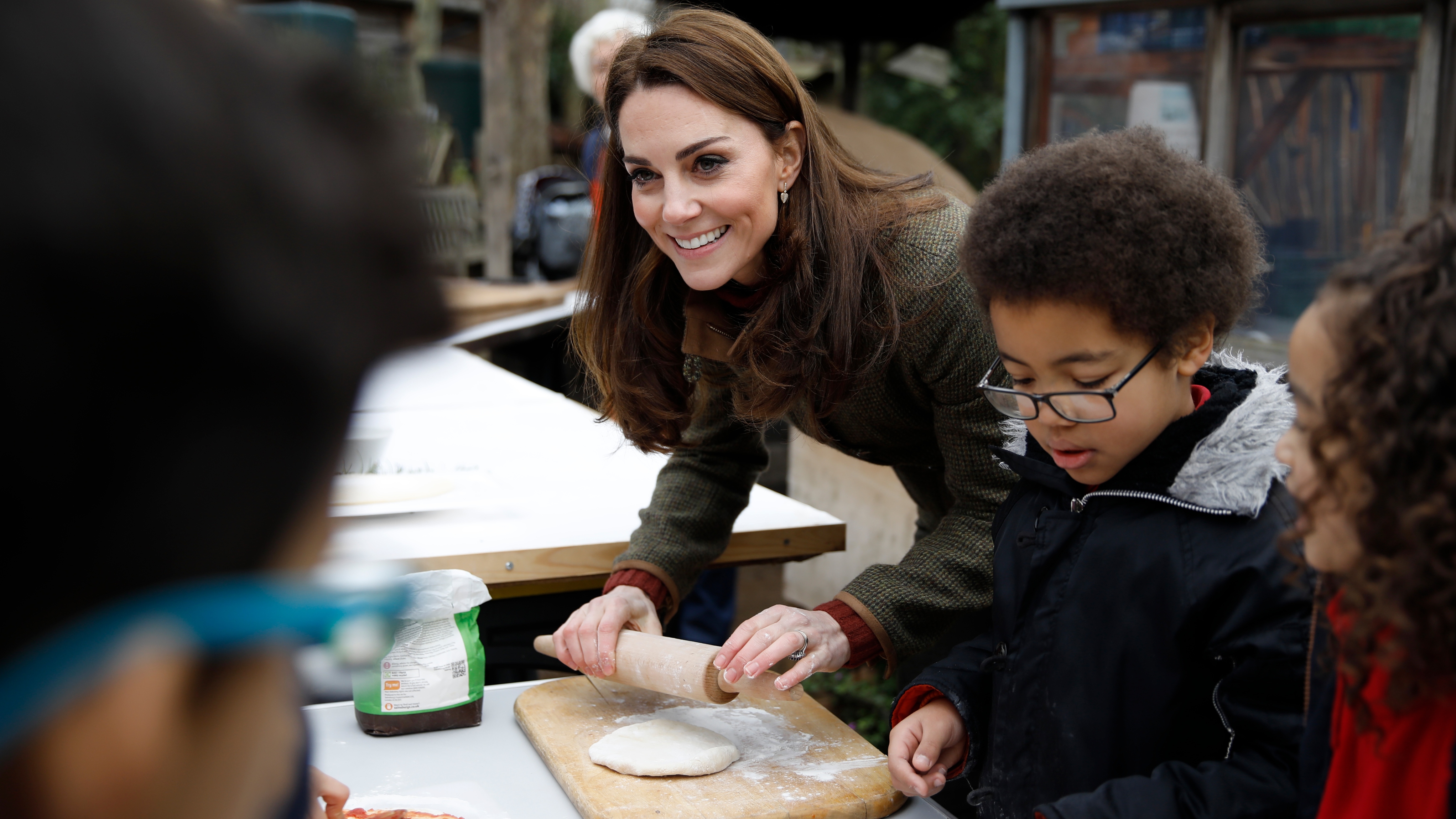 Catherine, Princess of Wales speaks with children and helps makes pizza as she visits Islington Community Garden