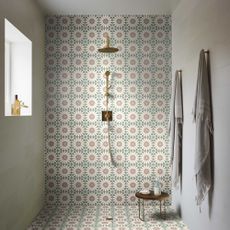 wet room with floral pattern tiles