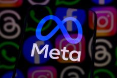 Meta logo appears on the screen of a smartphone placed on a reflective surface onto which the icons of Facebook, Instagram, WhatsApp, and other Meta apps are projected