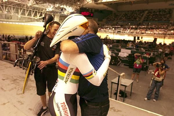 Anna Meares from Australia is congratulated by her coach Gary West after claiming gold in the women's 500 metres time-trial.