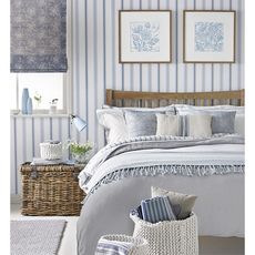 bedroom with stripes wallpaper and floral frame 