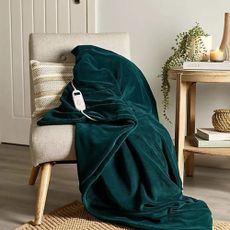 Green Lakeland heated blanket on chair