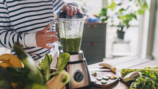 A woman using a blender