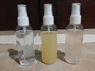 three different colored room sprays in transparent 100ml spray bottles with white lids