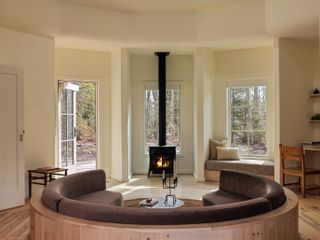 Scribner’s Catskill Lodge, The Rounds living room in bedroom featuring a chimney