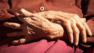 Close-up image of the hands of a centenarian.