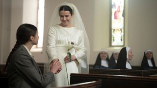 Sister Catherine is greeted by her sister as she arrives to say her vows while wearing a wedding dress